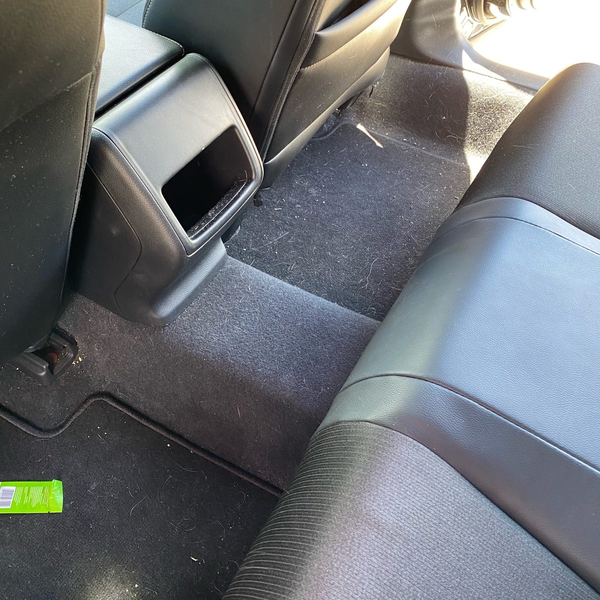 Honda Accord rear seats and carpet covered in lint and debris before vacuuming