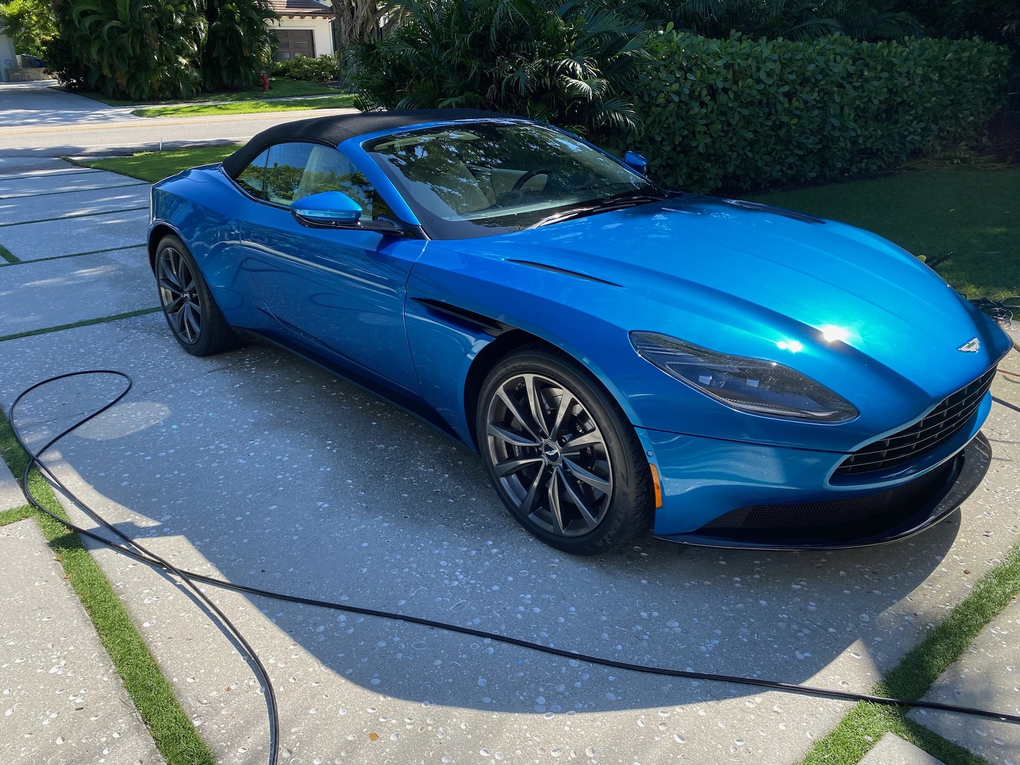 Blue Aston Martin DB11 Volante washed and detailed in a Naples, Florida driveway