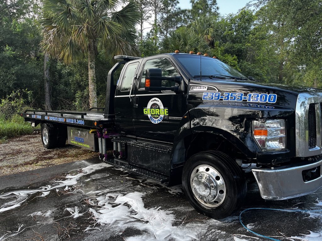 Black flatbed tow truck cleaned and finished, wheels and chrome done